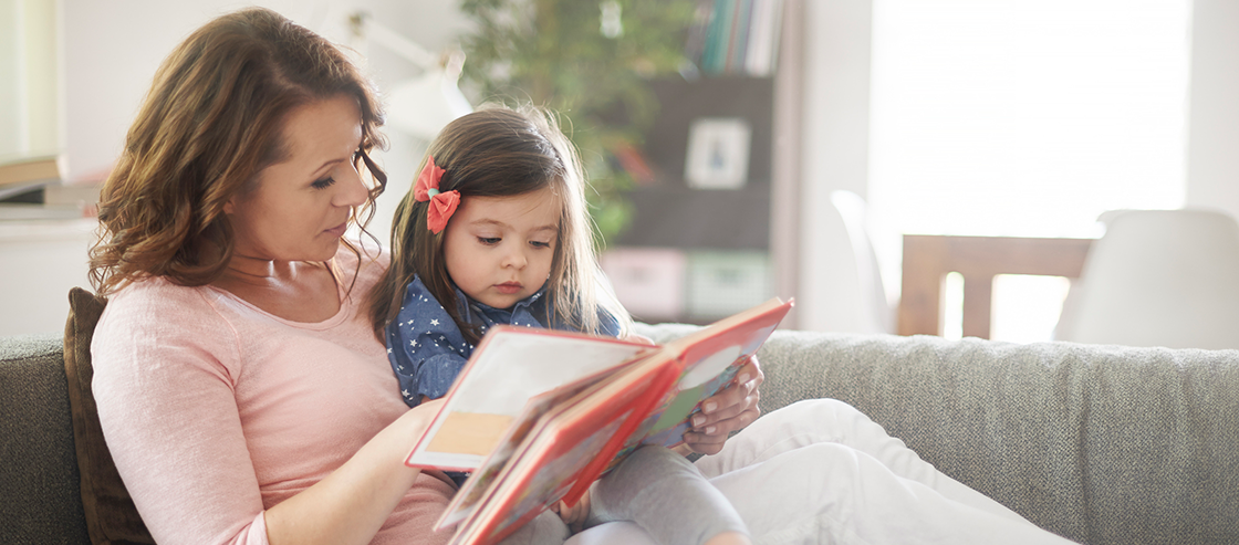 mother and daughter read on couch blog